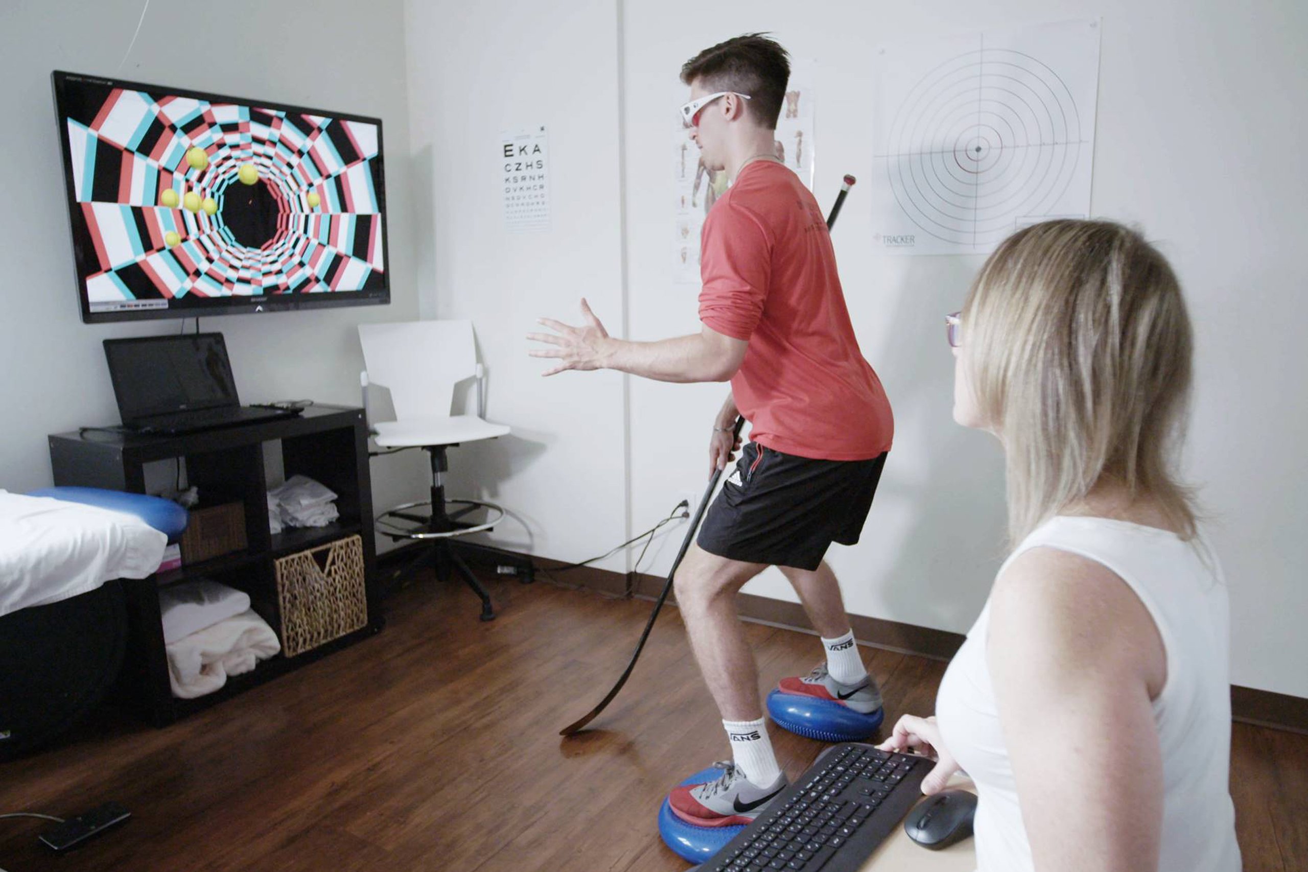 An individual performing the NeuroTracker Performance Slide, focusing on visual tracking and cognitive training in a controlled setting.